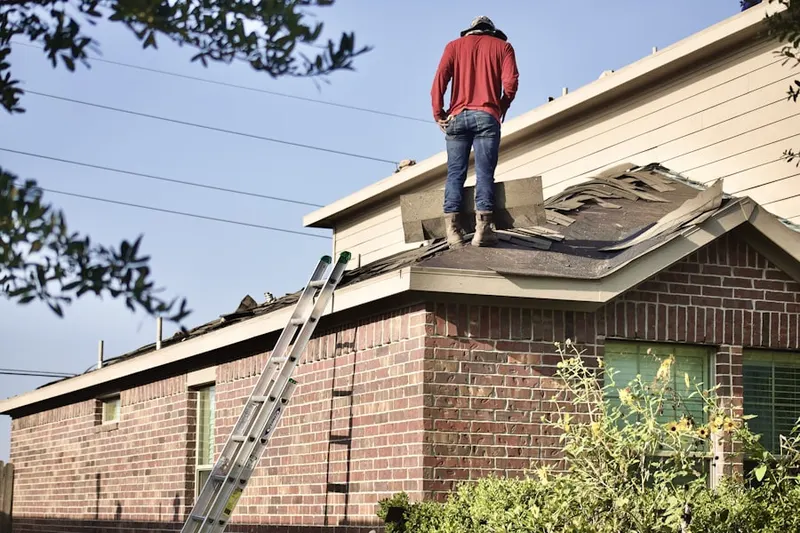 Professional roofer working on a residential roof in Camp Dennison